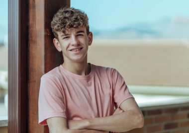 teenage boy crossing his arms