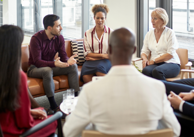 Group of people sat in a circle in discussion