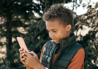 young boy using mobile phone