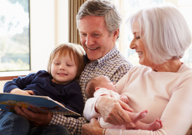 grandparents with a toddler and baby