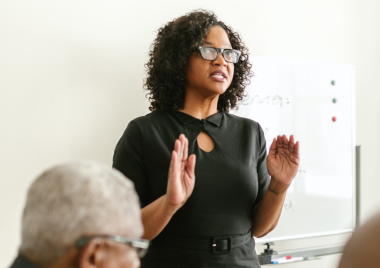 Woman speaking to a room of people
