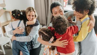 Parents hugging children