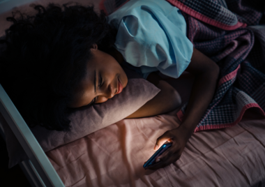 teen on their phone in the dark, before bed