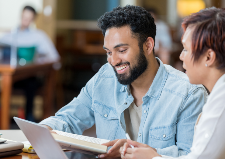 man with short hair and beard, wearing blue casual shirt
