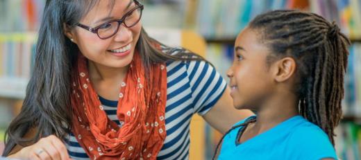 Adult and child looking at each other